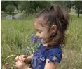  ?? Courtesy photo ?? Julia Robles, who is part of the YES Charter Academy School Readiness Program, holds flowers.