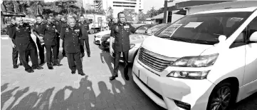  ??  ?? Johor Police chief Datuk Mohd Khalil Kader Mohd showing one of seven luxury vehicles seized with the arrest of 35 gang members in a large-scale nationwide operation in December last year and seizing assets worth over RM6.5 million. - Bernama photo