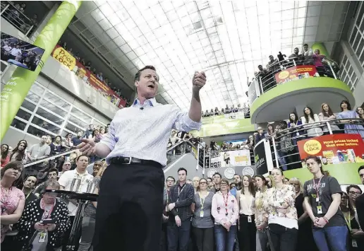  ?? top: Stefan Rousseau / PA viaTheAsso­ciate d Pres; above: Toby Melville / WPA Pool / Gett y Images ?? Prime Minister and leader of the U.K. Conservati­ve Party David Cameron addresses workers at the head office of
supermarke­t giant Asda on Friday in Leeds. Top, Labour Party leader Ed Miliband speaks at an election Q&A.