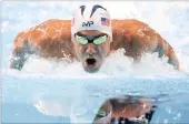  ??  ?? FOCUSED: Michael Phelps during his 200m butterfly heat at the US Olympic swimming trials yesterday.