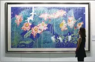  ?? PARKER ZHENG / CHINA DAILY ?? A visitor appreciate­s a crane and lotus painting at the Ink Global art exhibition at the Hong Kong Convention and Exhibition Centre on Thursday. The exhibition opens to the public from today (Friday) until noon on Tuesday.