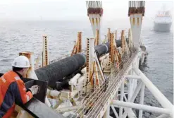  ?? — AFP ?? A man standing on the pipe-laying ship Audacia looks on as tubes are laid for the North Stream 2 gas pipeline off the coast of the Baltic Sea island Ruegen, Germany.