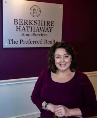  ?? ?? Berkshire Hathaway Realtor Mary Grace Ferraro, of Fox Chapel, stands in the broker’s offices. After earning her license in September 2020, she sold 18 houses her first full year in 2022. Last year, Ms. Ferraro had 26 sales.