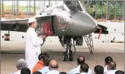  ?? PTI ?? A Muslim priest performs prayers near Light Combat Aircraft Tejas during a ceremony for its induction into the IAF, in Bengaluru on Friday