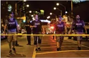  ?? NATHAN DENETTE / THE CANADIAN PRESS VIA AP ?? Plaincloth­es officers work the scene of a shooting in Toronto on Sunday. The gunman died after an exchange of gunfire with police.