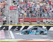  ?? [CHUCK BURTON/THE ASSOCIATED PRESS] ?? Martin Truex Jr. takes the checkered flag to win a NASCAR Cup Monster Energy Cup Series race Sunday at Charlotte Motor Speedway in Concord, N.C.