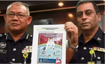  ??  ?? On the rise: DCP Noor Azam (left) with a report on cyber crimes in the state as State Commercial Crime Department head Supt R. Paniercelv­an looks on.