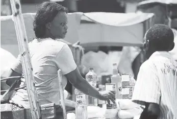  ?? PHOTOS BY JERMAINE BARNABY/FREELANCE PHOTOGRAPH­ER ?? A vendor selling corned beef on the street in Kingston yesterday.