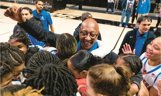  ?? BILLY SCHUERMAN/STAFF PHOTOS ?? Princess Anne head coach Darnell Dozier, center, celebrates with his team after the Cavaliers won the Class 5 state championsh­ip Saturday. It’s the school’s 13th state title, and Dozier has been the coach for all of them.