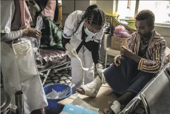  ?? Finbarr O'Reilly / New York Times ?? Health care workers treat a soldier Friday in Ethiopia’s northern Tigray region. Three aid workers employed by Doctors Without Borders were found killed in the wartorn area.