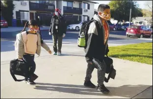  ?? ASSOCIATED PRESS ?? Students arrive Thursday at Newhall Elementary School Thursday in Santa Clarita. Elementary school students returned to school this week in the Newhall School District.