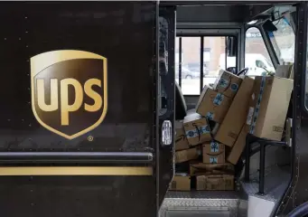  ?? Ap pHotos ?? SEND IT BACK: Packages await delivery inside of a UPS truck in 2018 in Baltimore. Shoppers, who can’t touch or feel products they're ordering, are expected to return items during the holiday season at a rate double from last year, costing retailers roughly $1.1 billion, according to Narvar Inc. At left, a customer is shown at the exchanges and returns counter at a Target store in Glendale, Colo., on Wednesday.