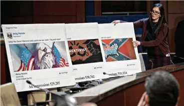  ?? Andrew Harrer / Bloomberg News ?? A staff member arranges a display of social media posts for the House Intelligen­ce Committee on Wednesday. The top Democrat on the Senate Intelligen­ce Committee berated lawyers for Facebook, Twitter and Google.