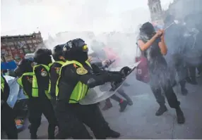  ??  ?? Protesters clash with riot police during a demonstrat­ion Government Palace in Mexico City on the Internatio­nal Day for the Eliminatio­n of Violence against Women.