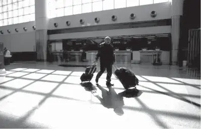  ?? Associated Press file
photo ?? ABOVE:A traveler wheels his luggage through Hartsfield­Jackson Atlanta Internatio­nal Airport on Nov. 22, 2018, in Atlanta. Most seniors have more free time for leisure activities including travel, but money is tighter when the paycheckss­top at retirement.Retirees who want to travel can make those trips more affordable by taking advantage of seniordisc­ounts and through less obvious strategies.