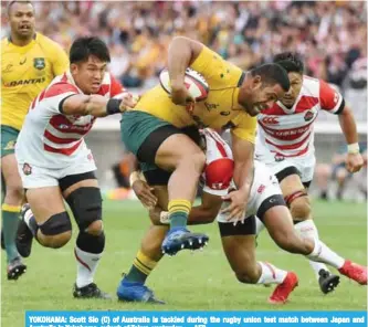  ??  ?? YOKOHAMA: Scott Sio (C) of Australia is tackled during the rugby union test match between Japan and Australia in Yokohama, suburb of Tokyo, yesterday. — AFP
