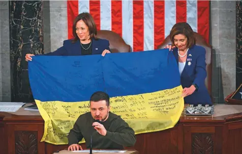  ?? AP ?? Ukraine’s President Volodymyr Zelensky speaks after giving a Ukrainian national flag to US Vice-President Kamala Harris and House Speaker Nancy Pelosi during his address the US Congress in Washington on Wednesday.