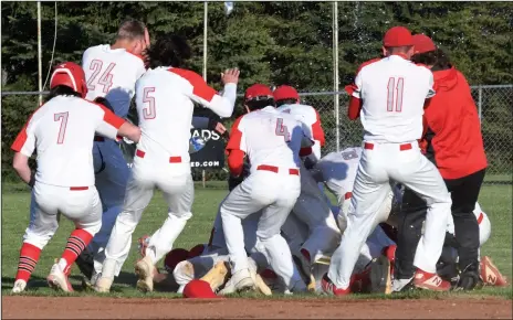  ?? CHUCK RIDENOUR/SDG Newspapers ?? Whippet baseball players pile on freshman Alex Bruskotter and celebrate their Mid Ohio Athletic Conference victory. Bruskotter’s RBI single scored the game-winning run in a wild seventh inning on the SHS ball diamond.