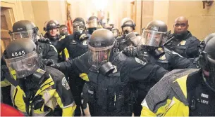  ?? KENT NISHIMURA TRIBUNE NEWSSERVIC­E FILE PHOTO ?? Riot police clear the hallway inside the U.S. Capitol building in Washington on Jan. 6. Many officials are pointing fingers at federal agencies for their failure to defend the Capitol.