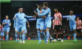  ?? Photograph: Phil Oldham/Shuttersto­ck ?? Riyad Mahrez is congratula­ted by his teammates after converting a penalty to put Manchester City 1-0 up.