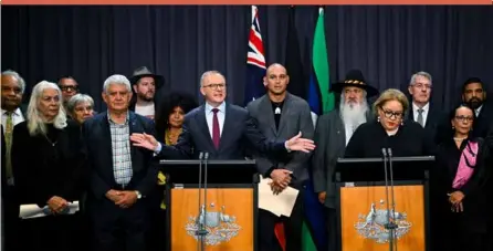  ?? ?? Australian Prime Minister Anthony Albanese, at the left podium, is surrounded by members of the First Nations Referendum Working Group during a press conference at Parliament House in Canberra