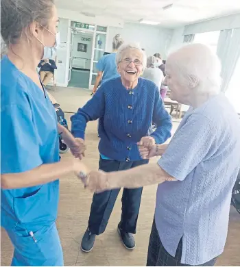  ?? ?? GIFTED: Lorna Alexander, centre, dances with Glenisla staff and residents and, below, in the infant room at Strathdon School in 1970 playing for pupils.