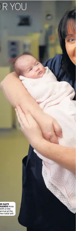  ??  ?? IN SAFE HANDS Anne with a new arrival at the neo natal unit