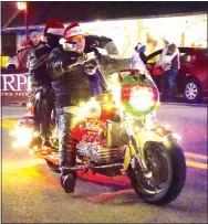  ?? Photo by Randy Moll ?? A number of motorcycle­s, decorated for the season, cruised by during the annual Gentry Chamber of Commerce Christmas Parade on Saturday.