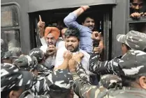  ?? MANISH SWARUP ?? POLICE detain Congress party workers during a protest against last week’s deadly communal riots in Delhi, India, on Monday. | AP