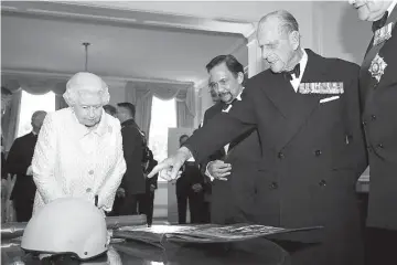  ??  ?? Prince Philip with Queen Elizabeth and Brunei’s Sultan Hassanal Bolkiah during the Gurkha 200 pageant in the grounds of the Royal Hospital Chelsea in London on Tuesday. — Reuters photo