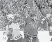  ?? Nick Wass / Associated Press ?? Washington’s Alex Ovechkin, right, celebrates the first of his four goals after scoring in the first period of Saturday night’s game against visiting Montreal. Ovechkin also had a hat trick in the Capitals’ seasonopen­ing victory at Ottawa on Thursday.