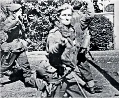  ??  ?? Jack Reynolds giving his captors a two-fingered salute (and, below, in 2016). ‘The Germans thought that it was a Churchilli­an V for Victory sign,’ he recalled. ‘I didn’t disillusio­n them.’ Above right, British airborne troops landing behind enemy lines in Holland in September 1944
