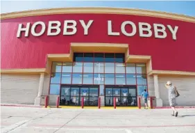  ?? ASSOCIATED PRESS FILE PHOTO ?? Customers walk to a Hobby Lobby store in Oklahoma City. Federal prosecutor­s say Hobby Lobby Stores has agreed to pay a $3 million federal fine and forfeit thousands of ancient Iraqi artifacts smuggled from the Middle East the government alleges were...