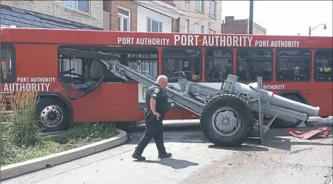  ?? Anthony Conroy/Post-Gazette ?? The Port Authority bus that crashed into a Brookline Veterans Memorial cannon came to a rest against a wall and railing on July 8. No one was injured. The driver blamed mechanical problems; the Port Authority cited unsafe speeds.