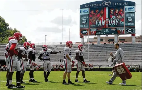  ?? PHOTOS CONTRIBUTE­D BY RICHARD HAMM ?? UGA’s offensive line features a few bigger players this season, which their coaches expect will make it easier for the Bulldogs, who include a couple of standout running backs, to successful­ly run between the tackles.