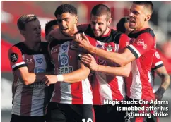  ??  ?? Magic touch: Che Adams is mobbed after his
stunning strike