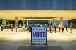  ?? JAY JANNER/AUSTIN AMERICAN-STATESMAN ?? People wait in line to vote at the Lyndon B. Johnson School of Public Affairs during the midterm elections on Nov. 8 in Austin, Texas.