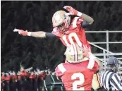  ?? Jeremy Stewart / RN-T ?? Rome High’s Trai Hodges (10) celebrates with teammate Jamarcus Chatman after Hodges returned an intercepti­on for a touchdown against SW DeKalb during the second quarter of Friday’s Class 5A state playoff game.