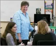  ?? THE ASSOCIATED PRESS ?? Lee Ann Wentzel, center, superinten­dent of the Ridley School District, speaks with Kim Holdredge, left, and Sarah Messina during a graphic design class April 28 at Ridley High School in Folsom, Pa.