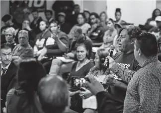  ?? Michael Ciaglo, Special to The Denver Post ?? Pedro Carrillo asks a question during a town hall meeting Wednesday at the City and County Building to discuss raising the minimum wage.