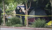  ?? (AP/The Sacramento Bee/Hector Amezcua) ?? Police investigat­e the site where a homeless woman was stabbed several times through the side of her tent near Second and L streets Tuesday in Davis, Calif. Three people were stabbed within a week, including two fatally.