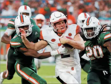  ?? WILFREDO LEE - THE ASSOCIATED PRESS ?? Miami defensive back Jhavonte Dean (6) and defensive back Robert Knowles (20) take down Syracuse quarterbac­k Eric Dungey during the second half in a game from Saturday, Oct. 21, 2017.