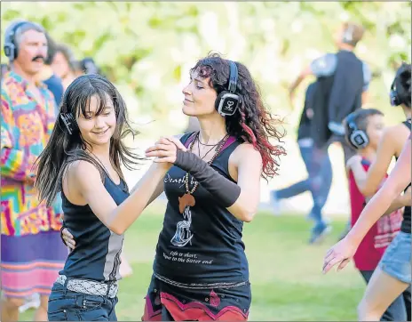  ?? Pictures: TOO SOCIAL PTY LIMITED ?? FINDING THEMSELVES: Some of the participan­ts feeling the peace during the Secret Sunrise in Happy Valley yesterday