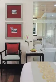  ??  ?? For those who want a more neutral and contempora­ry approach, showcase singular Indian design elements such as the targeted use of ruby red in artwork and a throw pillow shown here at the Oberoi Mumbai.