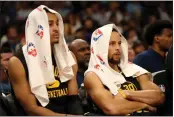  ?? ?? Jordan Poole and Stephen Curry watch as the Grizzlies build a 50-point lead in third quarter of Game 5.