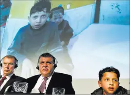  ?? Peter Dejong ?? The Associated Press Eleven-year-old Syrian Hasan Diab talks during a press conference as a part of the video with his image is shown Thursday in The Hague, Netherland­s.