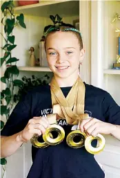  ?? ?? Alice Johnson shows off her four Australian Gymnastics Gold medals at her home in Nilma.