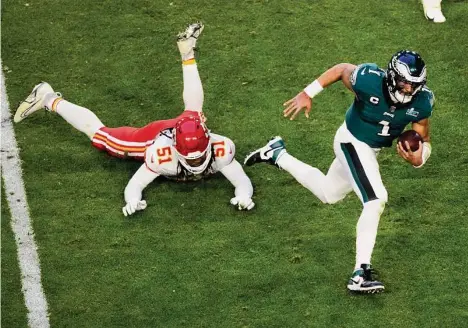  ?? Charlie Riedel/Associated Press ?? Eagles quarterbac­k Jalen Hurts became the third player in history to account for 370 yards and four touchdowns in a Super Bowl.