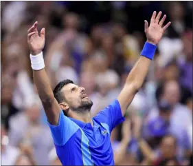  ?? MANU FERNANDEZ — THE ASSOCIATED PRESS ?? Novak Djokovic raises his arms and looks to the sky after defeating Daniil Medvedev in the men’s singles final of the U.S. Open on Sunday in New York.