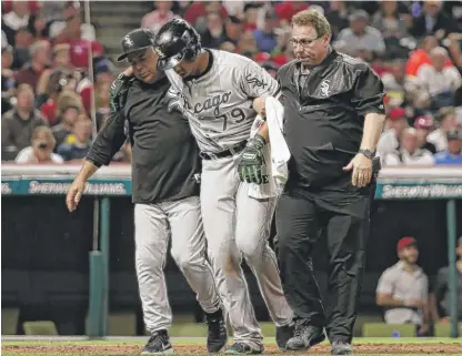  ?? | GETTY IMAGES ?? Jose Abreu is helped off the field in the seventh inning by manager Rick Renteria ( left) and trainer Herm Schneider.